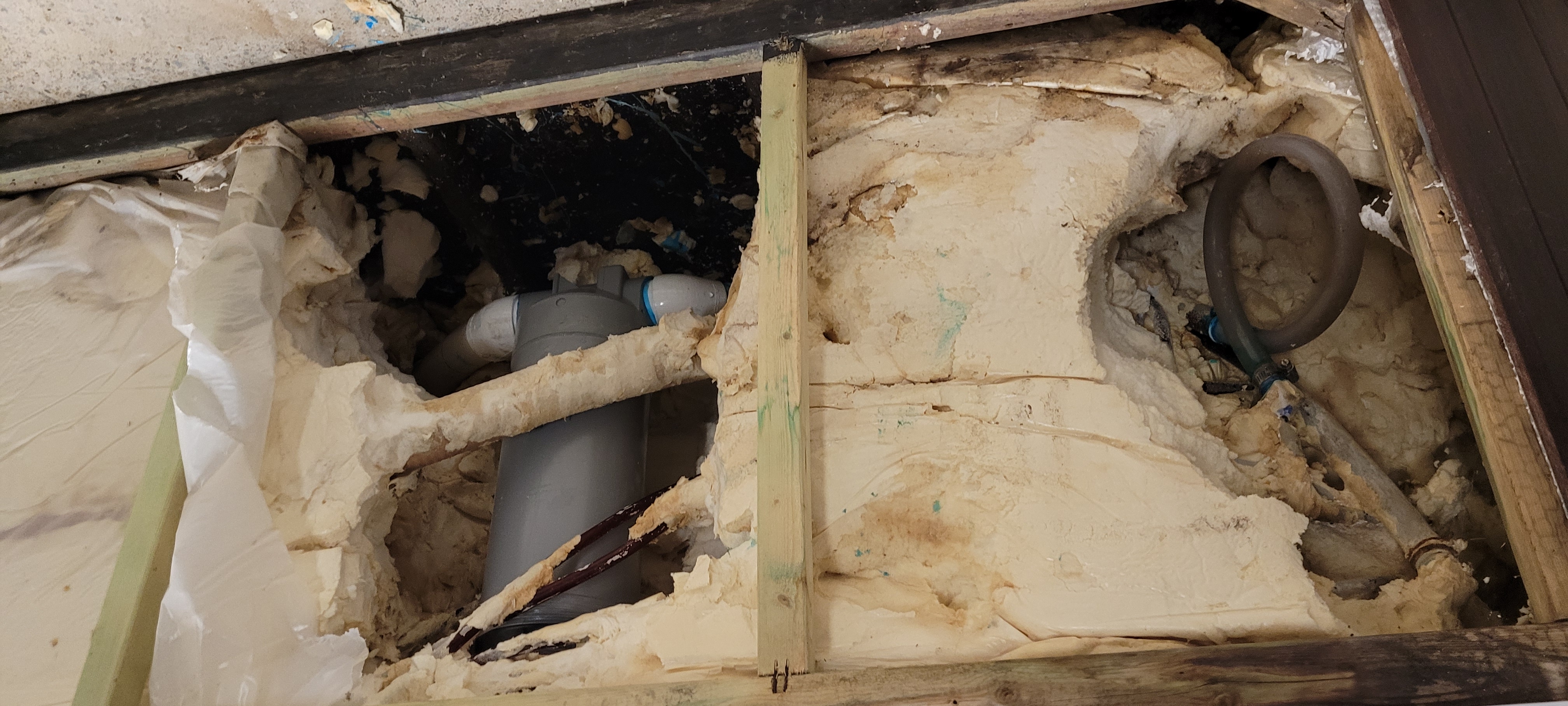 Wet wood frame visible with water stains and rotting timber inside a full foam hot tub cabinet
