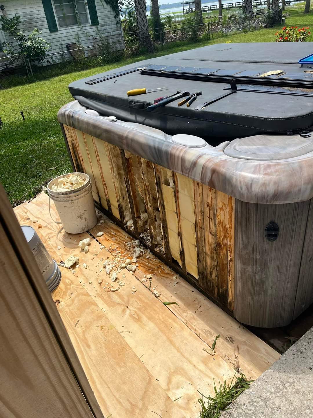 Same full foam hot tub with panels removed revealing water-damaged foam and rusted framework